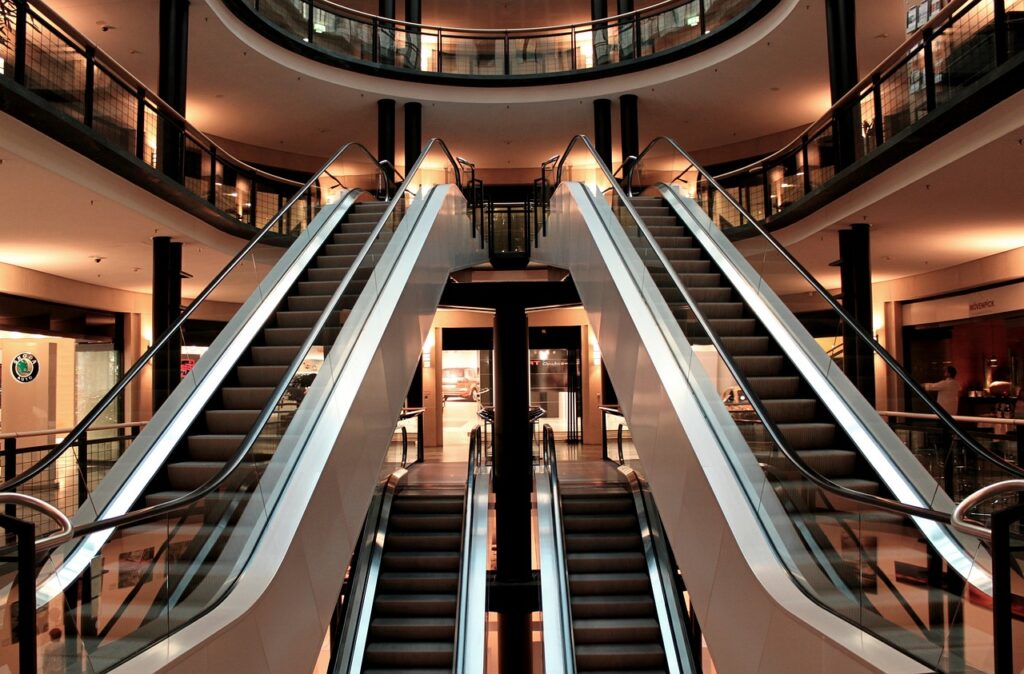 Inside image of an escalator with some yellow lights